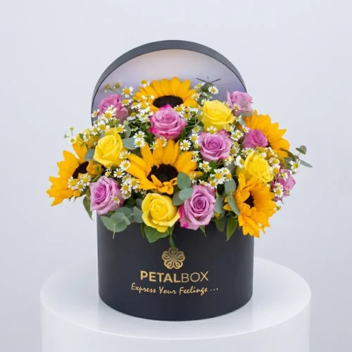 Luxury sunflower and rose flower box arrangement with yellow sunflowers, lavender and yellow roses, chamomile flowers, and eucalyptus in a premium black Petal Box for elegant gifting in Abu Dhabi and Dubai.