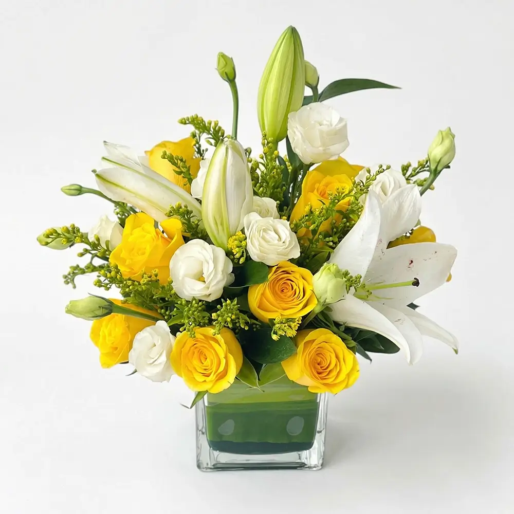 yellow and white easter flower arrangement with roses lilies in glass vase uae delivery